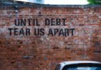 until debt tear us apart brick wall vandal