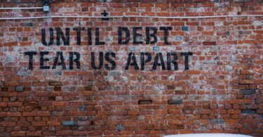 until debt tear us apart brick wall vandal