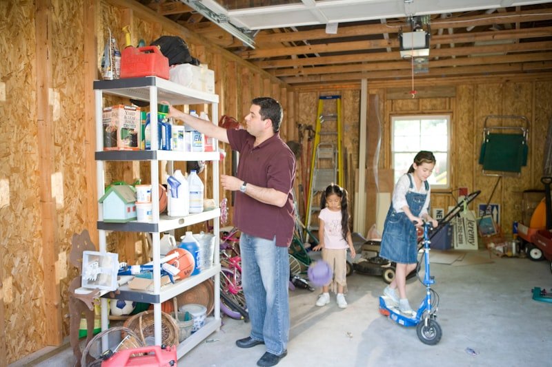 man in brown crew neck t-shirt and blue denim jeans standing beside girl in pink