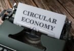 a close up of a typewriter with a paper that reads circular economy