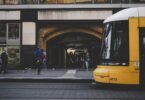 man standing near yellow bus