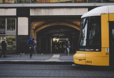 man standing near yellow bus