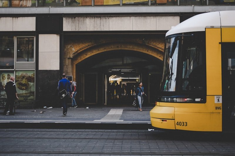 man standing near yellow bus